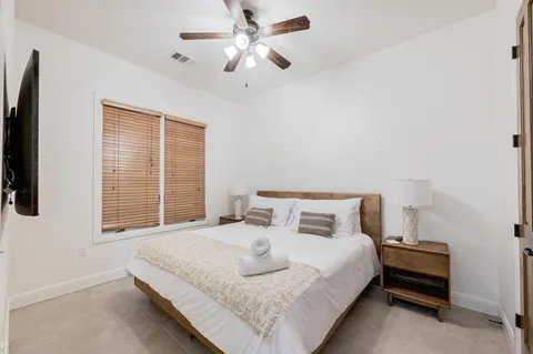 a bedroom with a bed and a large window