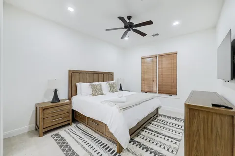 a bedroom with a bed and a night stand