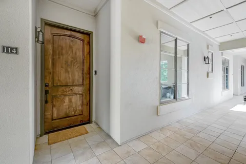 a view of a hallway with wooden cabinets