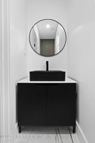 a bathroom with a sink a mirror a toilet and a shower