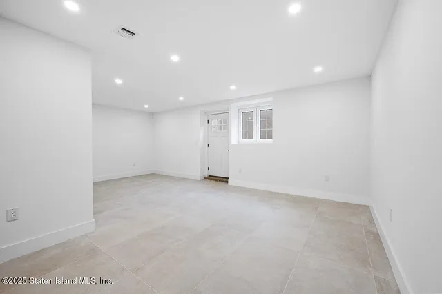 a view of a hallway to a livingroom with furniture and wooden floor