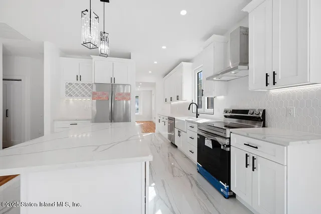 a kitchen with stainless steel appliances kitchen island granite countertop a sink and cabinets
