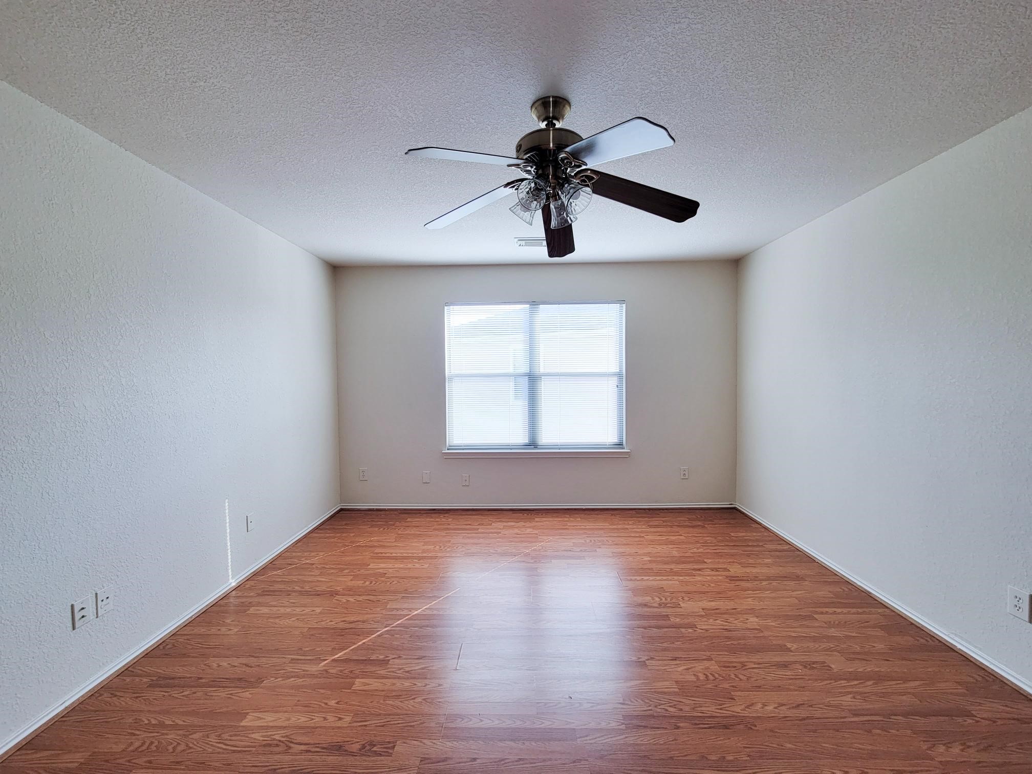 16306 Kendons Way Lane Cypress, TX 77429 - Photo 33 of 39 a view of an empty room with wooden floor and a window