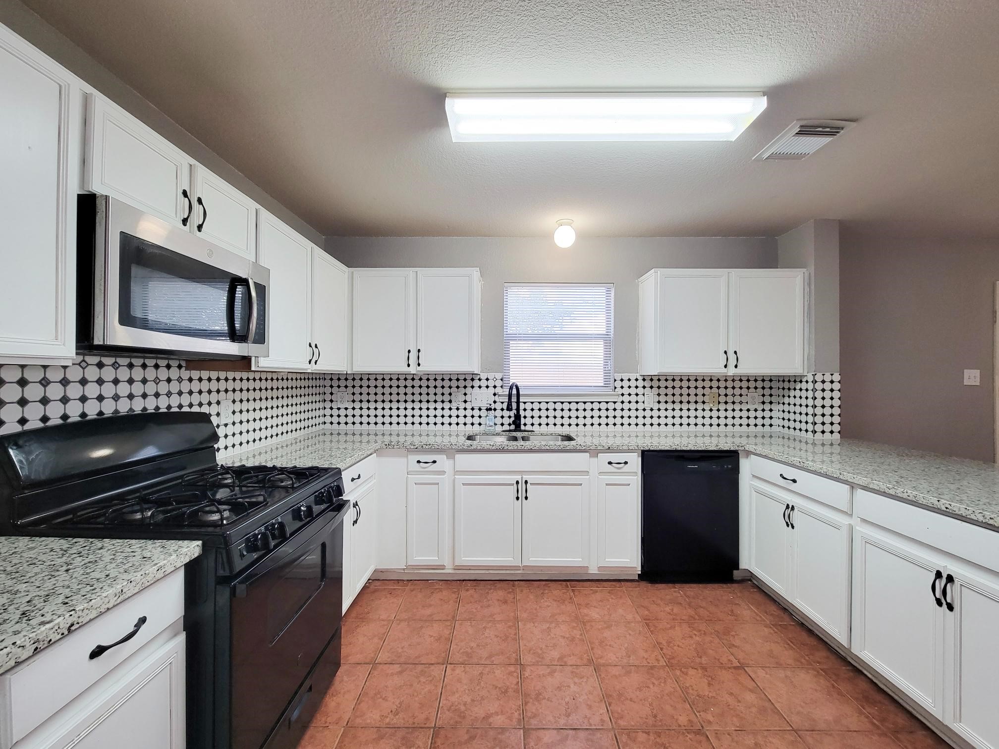 16306 Kendons Way Lane Cypress, TX 77429 - Photo 6 of 39 a kitchen with a sink stove top oven and cabinets