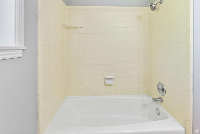 415 East 1150th Street North Logan, UT 84341 - Photo 15 of 38 Bathtub with a shower head, wall-mounted faucet, and built-in soap dish