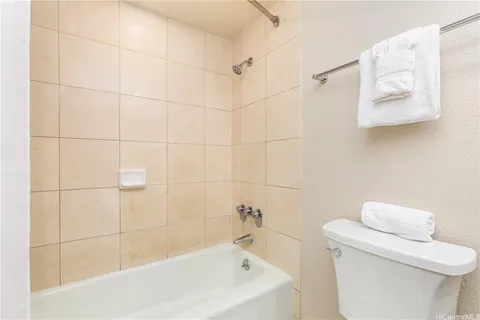 a bathroom with a bathtub and a toilet