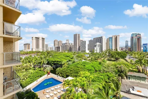 a view of a city with tall buildings and a big yard