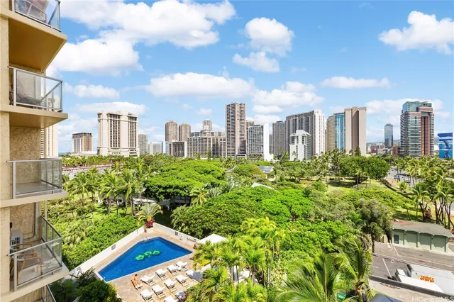 a view of a city with tall buildings and a big yard