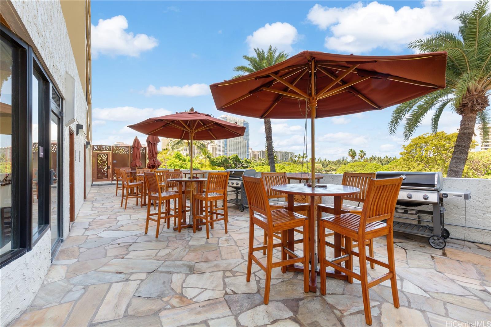 2045 Kalakaua Avenue, Unit 604 Honolulu, HI 96815 - Photo 19 of 24 a view of patio with chairs and table under an umbrella with a barbeque