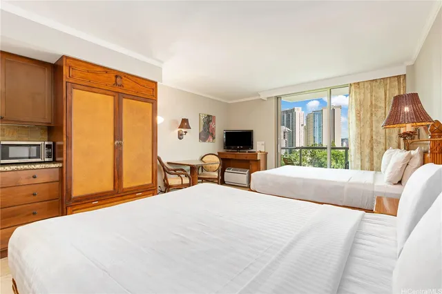 a bedroom with a bed a large window and flat screen tv