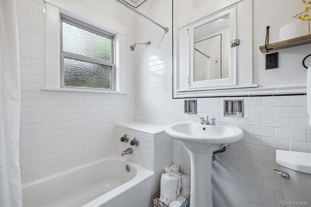 a bathroom with a sink mirror toilet and bathtub