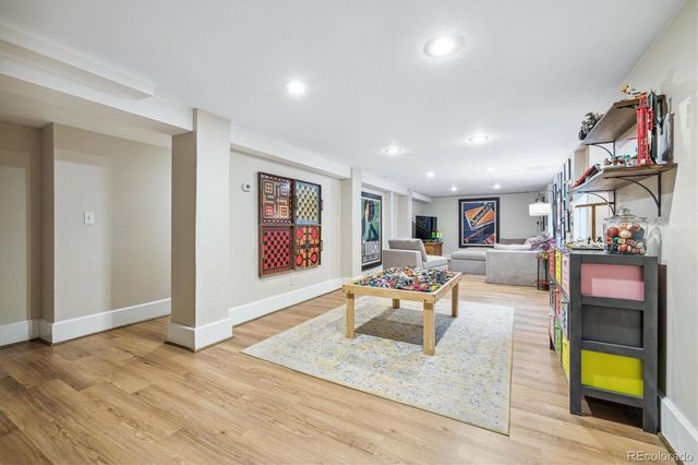 a living room with furniture and a bookshelf