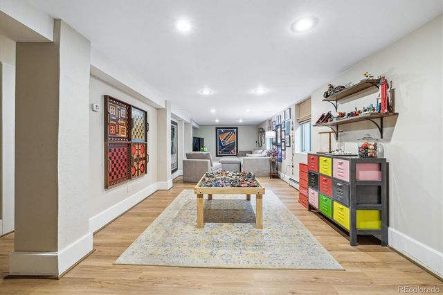 a living room with furniture and a book shelf