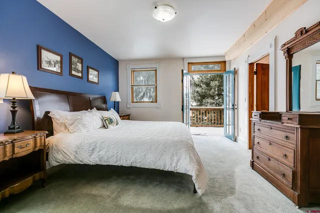 a bedroom with two beds and painting on the wall