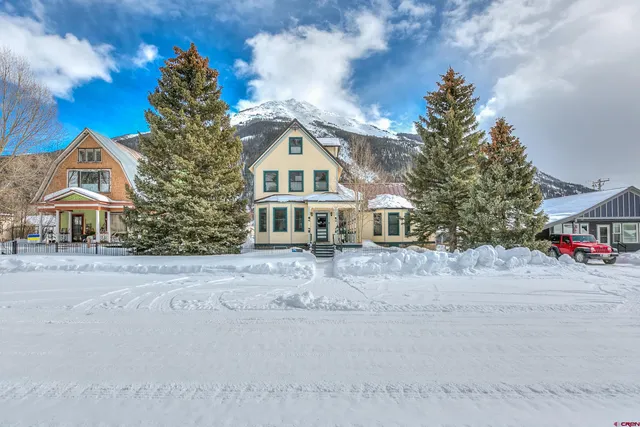 a front view of a house with sitting area and garden