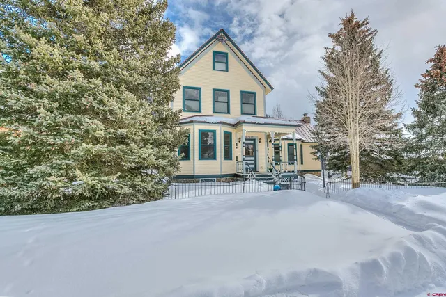a view of a dining room with furniture and a bookshelf