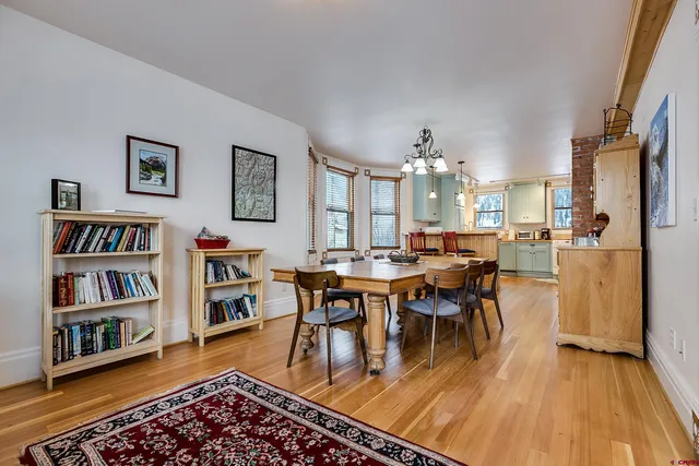 a living room with fireplace furniture and a large window