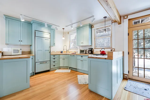 a dining room with furniture and wooden floor