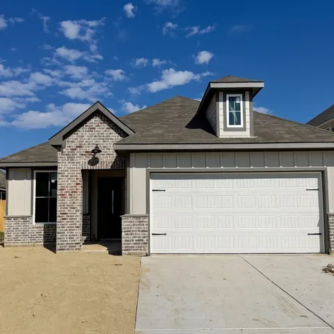 a front view of a house with a garage