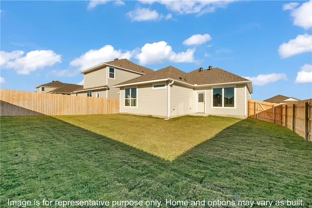 a view of a house with a backyard