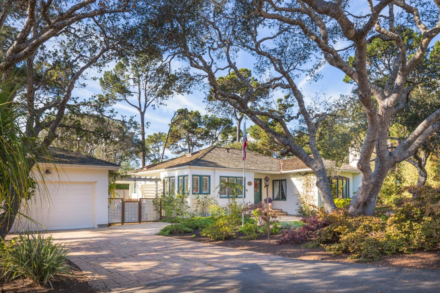 a front view of a house with a garden