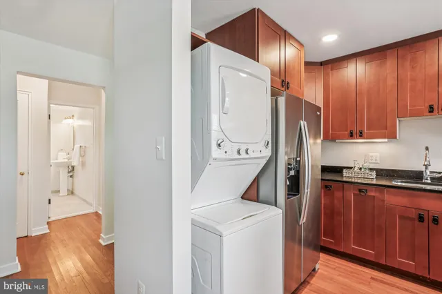 a kitchen with a refrigerator a sink and cabinets
