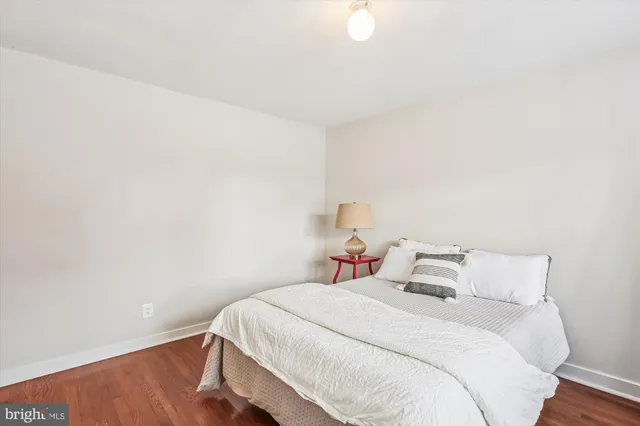 a bedroom with a bed and a night stand