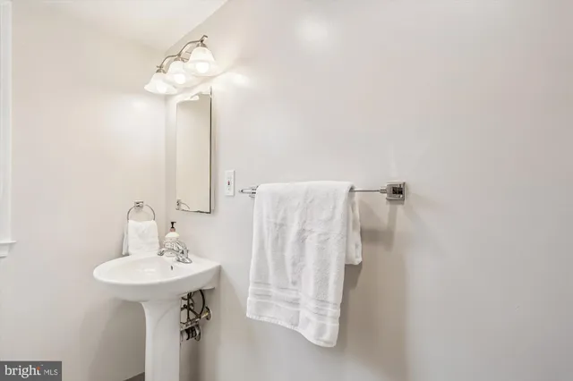 a bathroom with a sink a mirror and a shower