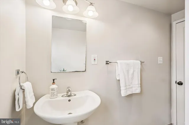 a bathroom with a sink and mirror