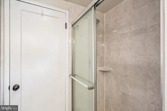 a bathroom with a shower and a glass door