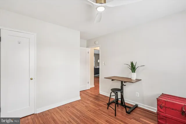 a view of a workspace with furniture and wooden floor