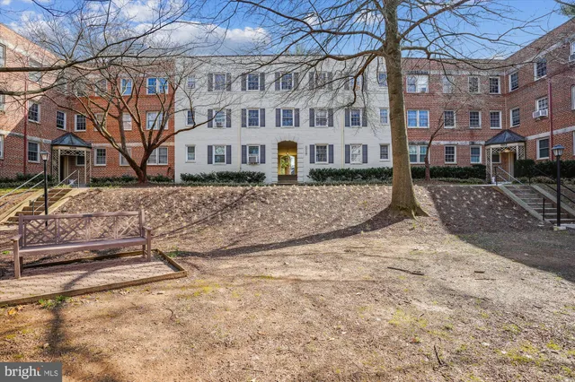 a view of a brick house with a yard