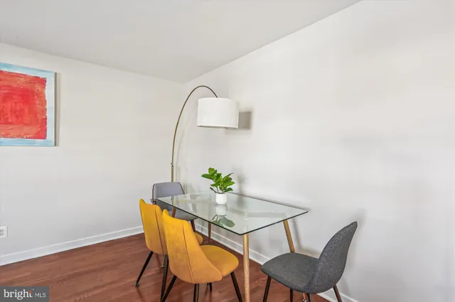 a dining room with furniture and wooden floor