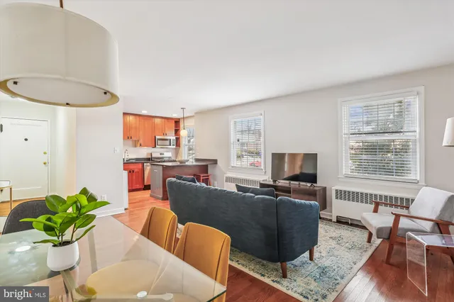a living room with furniture a flat screen tv and a window