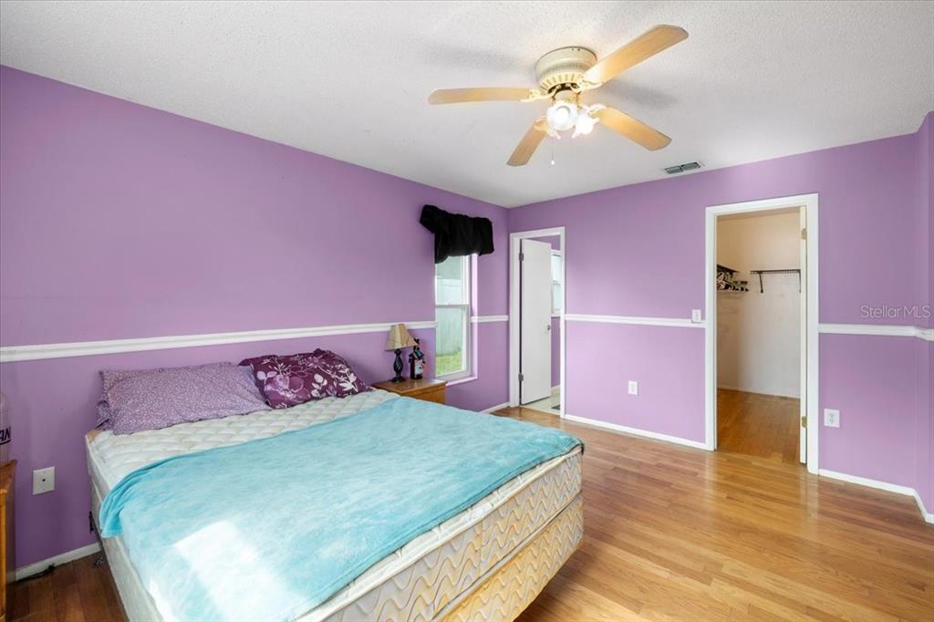 10290 Bannock Street Spring Hill, FL 34608 - Photo 13 of 40 a bed room with a bed and a chandelier