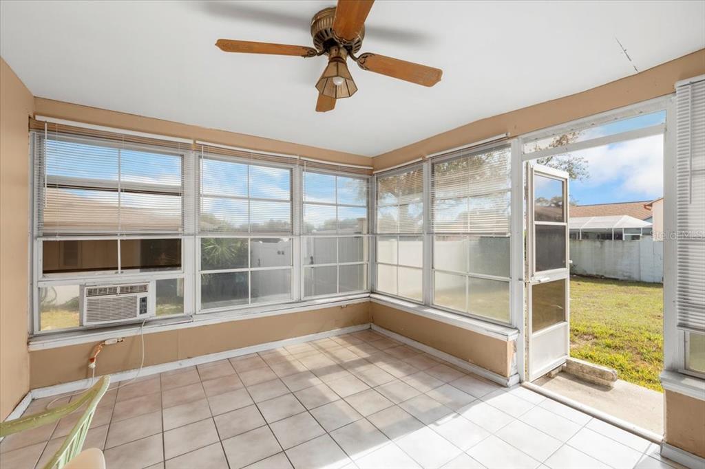 10290 Bannock Street Spring Hill, FL 34608 - Photo 16 of 40 a view of a livingroom with a fireplace and windows