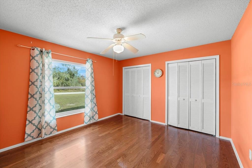 10290 Bannock Street Spring Hill, FL 34608 - Photo 18 of 40 wooden floor in an empty room with a window