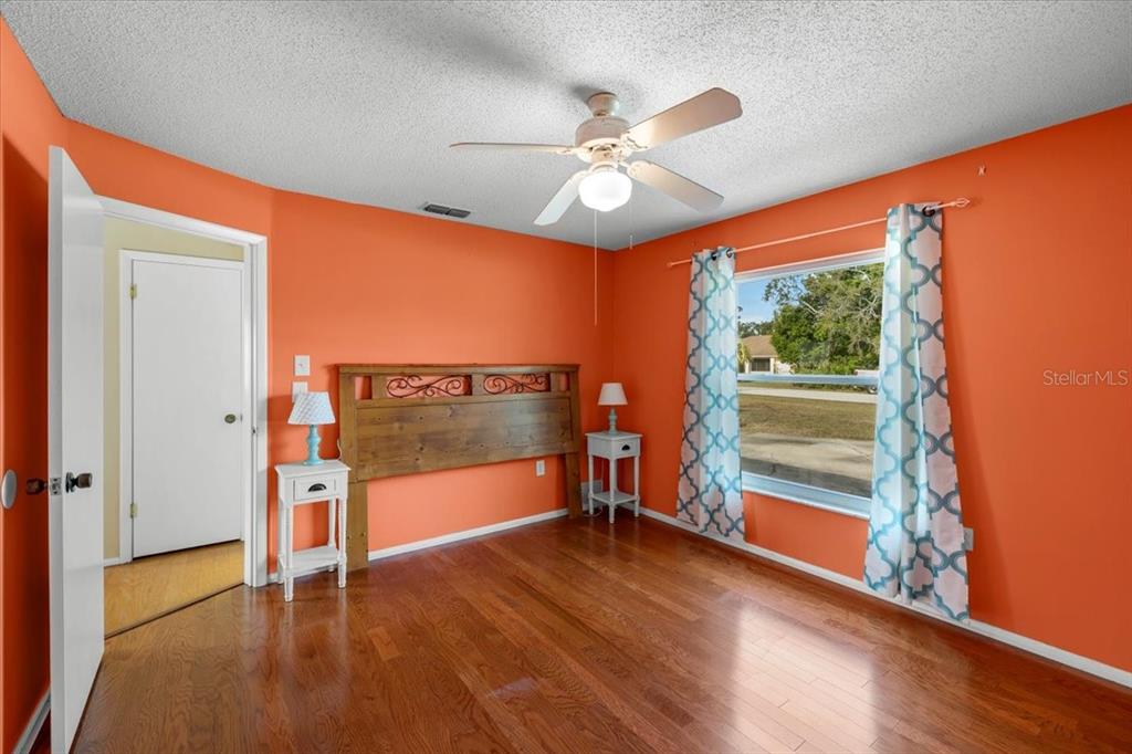 10290 Bannock Street Spring Hill, FL 34608 - Photo 19 of 40 wooden floor in an empty room with a window