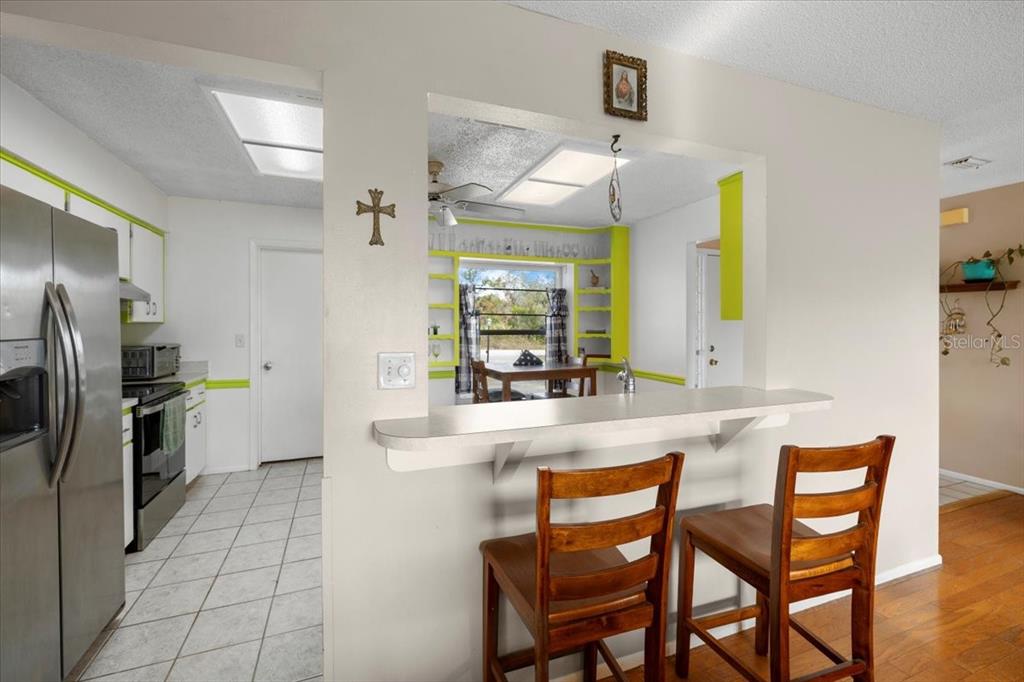 10290 Bannock Street Spring Hill, FL 34608 - Photo 7 of 40 a kitchen with stainless steel appliances a sink stove and refrigerator