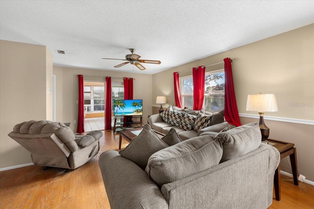 10290 Bannock Street Spring Hill, FL 34608 - Photo 9 of 40 a living room with furniture a ceiling fan and a window