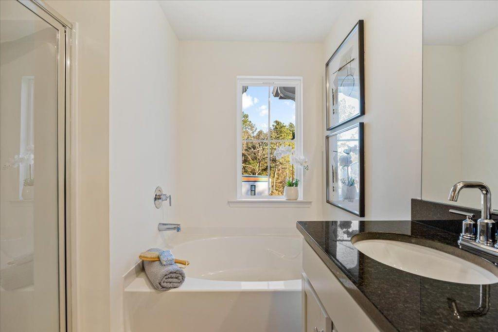 2555 Riverside Court Northeast Conyers, GA 30013 - Photo 24 of 33 a bathroom with a tub sink and mirror