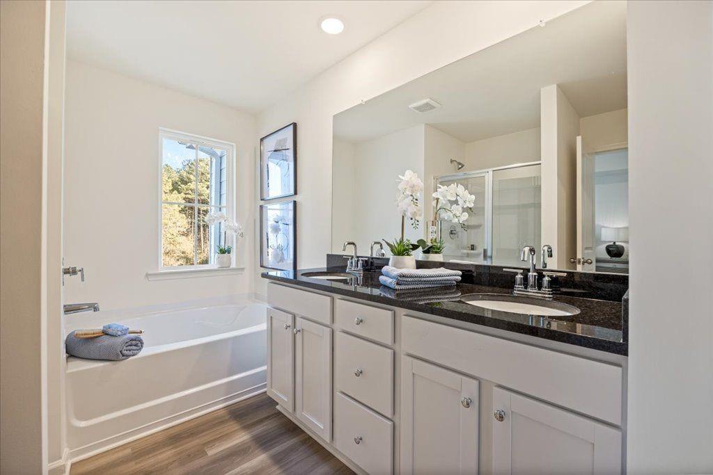2555 Riverside Court Northeast Conyers, GA 30013 - Photo 27 of 33 a bathroom with a tub sink and mirror