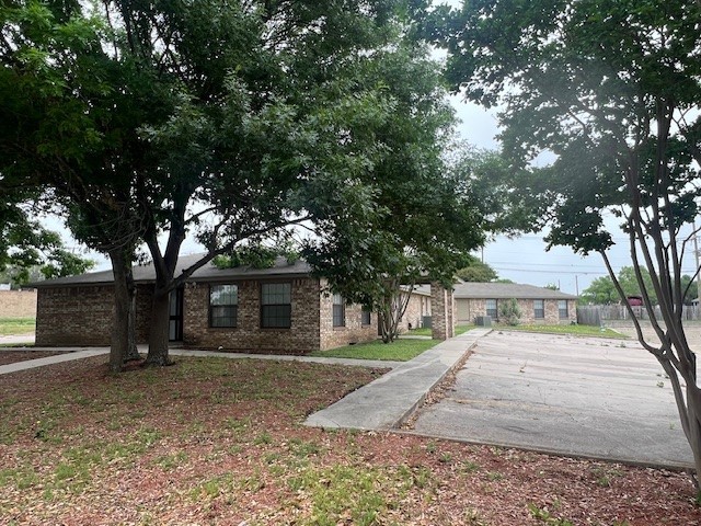 Undisclosed Address Killeen, TX 76543 - Photo 4 of 15 a view of a white house with a large tree