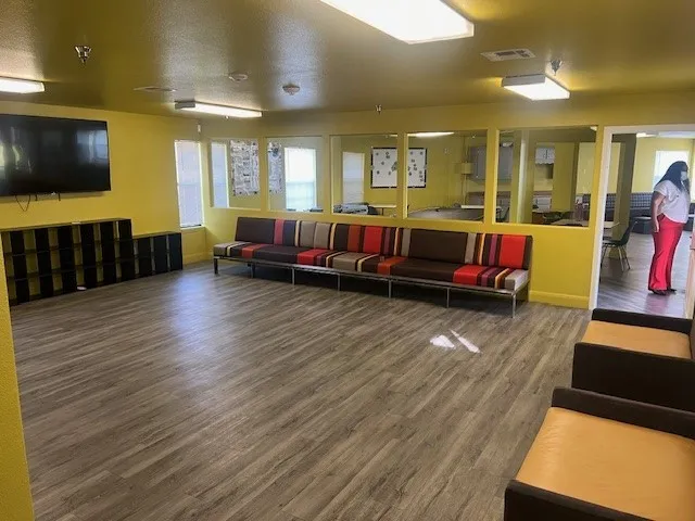a living room with furniture and a flat screen tv