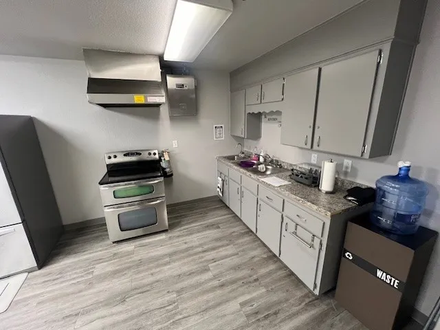 a kitchen with stainless steel appliances a stove a sink dishwasher and a refrigerator