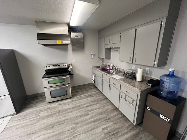 Undisclosed Address Killeen, TX 76543 - Photo 10 of 15 a kitchen with stainless steel appliances a stove a sink dishwasher and a refrigerator