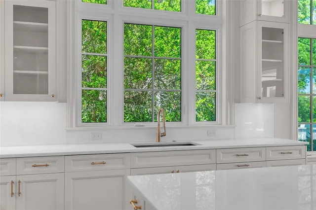 a kitchen with kitchen island a sink and wooden floor