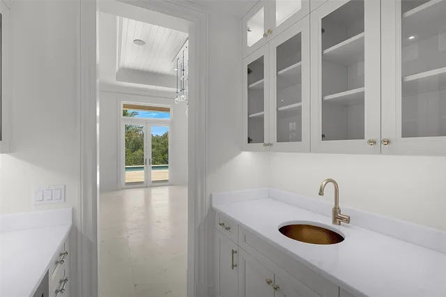 a view of a kitchen with sink and washer dryer