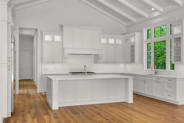 a kitchen with stainless steel appliances granite countertop a stove a sink and a refrigerator