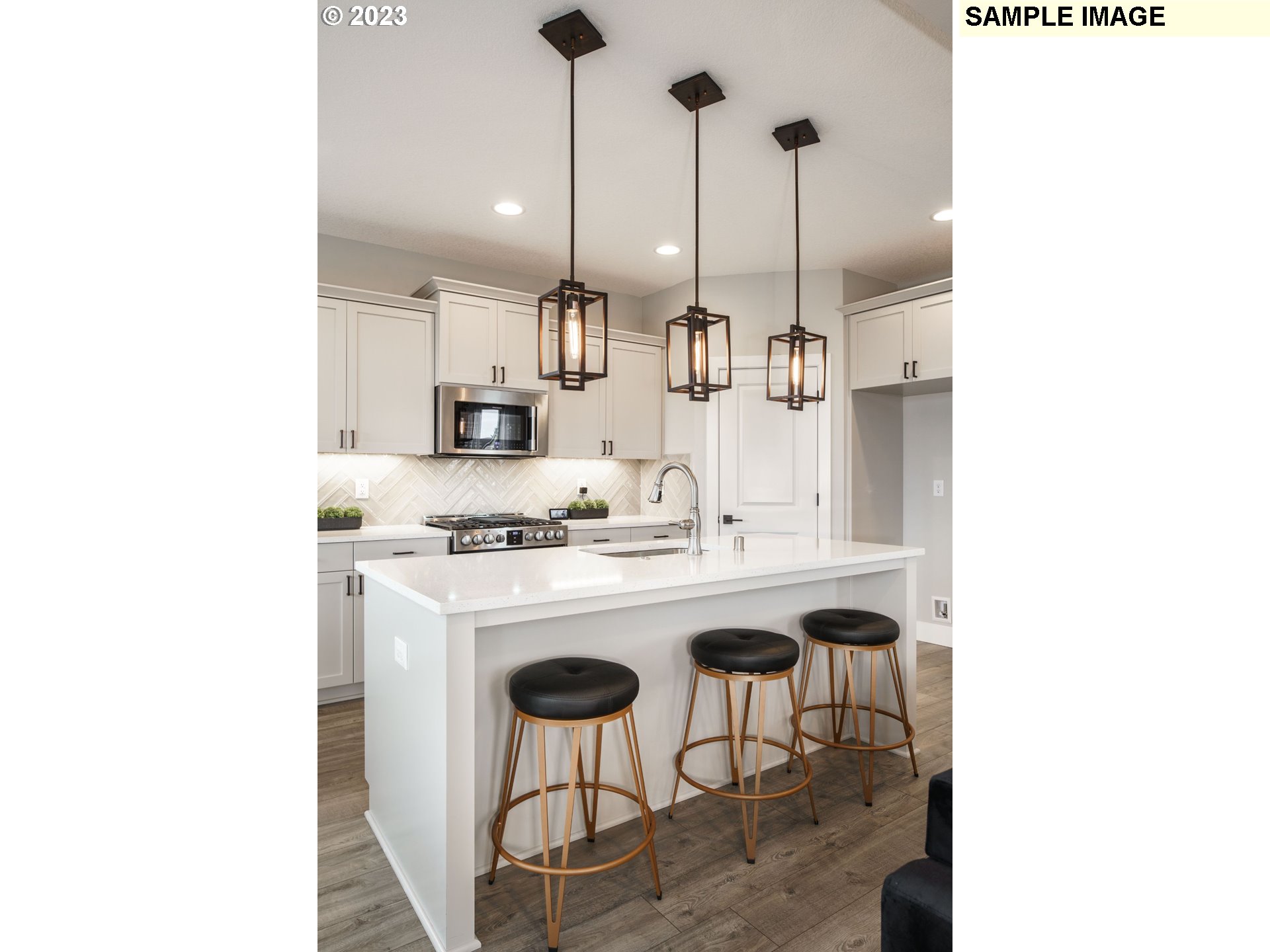 714 Northwest 178th Street Ridgefield, WA 98642 - Photo 11 of 31 a kitchen with a sink a stove and chairs